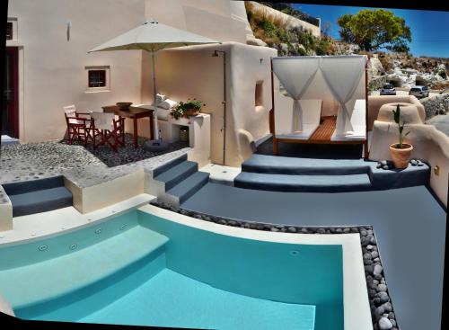 a house with a swimming pool with stairs and a table at Abelis Canava Luxury Suites in Vóthon