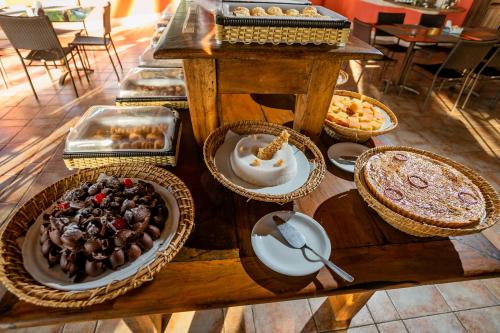 a table topped with plates of food and desserts at Patachocas in Morro de São Paulo