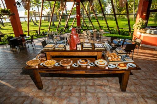 a table with a bunch of food on it at Patachocas in Morro de São Paulo