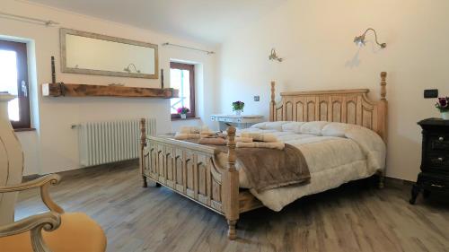 Schlafzimmer mit einem Holzbett und einem Spiegel in der Unterkunft B&B Dalù in Finale Ligure