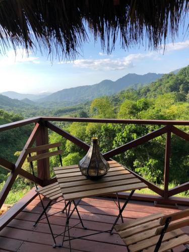 a vase sitting on a wooden table on a balcony at Reserva Natural Tierra Adentro in Minca