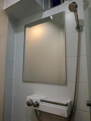 a mirror on a wall above a toilet in a bathroom at Seoul Forest Stay in Seoul