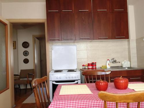 a kitchen with a table with red apples on it at Sofia Apartment in Ohrid