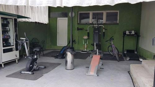 a gym with bikes and exercise equipment in a room at Aheloy Apartments in Aheloy