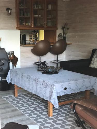 a living room with a table and a couch at Bondegårdsparken Farm Holiday in Kristiansand