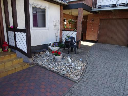 a porch of a house with a table and a patio at Ferienwohnung Ehmann in Schneverdingen