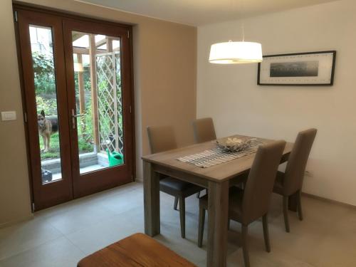 a dining room with a wooden table and chairs at B&B La Maison D' Amelie Camere e Appartamenti in Fenis