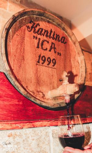 a barrel of wine being poured into a glass at Friends' Guesthouse & Hostel in Gjirokastër