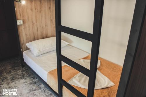 a glass door with a bed in a room at Friends' Guesthouse & Hostel in Gjirokastër