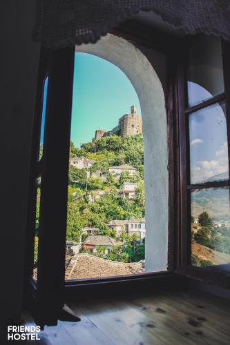 an open window with a view of a mountain at Friends' Guesthouse & Hostel in Gjirokastër