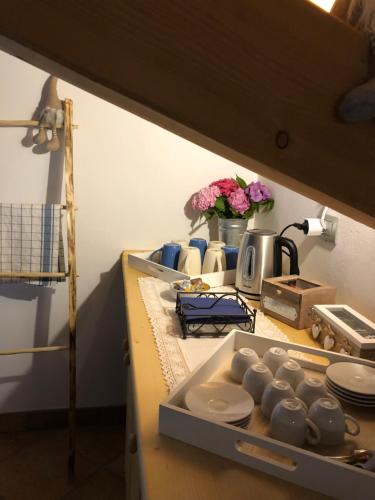a kitchen counter with plates and other items on it at B&B Maso Zont Antico Maso in Vignola