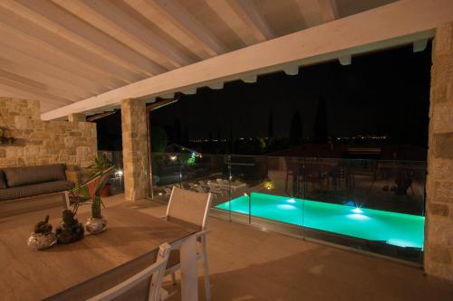 a patio with a view of a swimming pool at night at Italianflat - Maison du Lac in Lazise