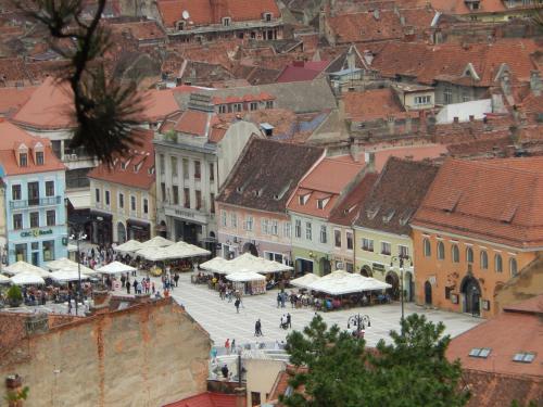 a view of a city with people walking in the street at 4 Rooms Piata Sfatului in Braşov