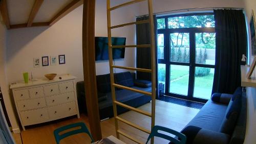 a living room with a blue couch and a mirror at DUNE Apartments in Mielno