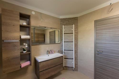 a bathroom with a sink and a mirror at Apartments Sandra with free private parking in Rijeka