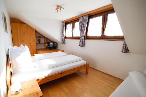 a room with three beds in a attic at Appartement Haus Moser in Sankt Michael im Lungau