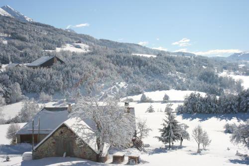 a house covered in snow in a snowy mountain at Domaine de l'Adoux in Saint-Jean Montclar