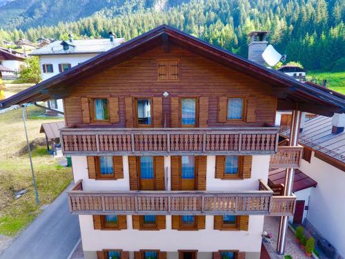 an aerial view of a large wooden house with a balcony at Ajarnola Locazioni Turist in Auronzo di Cadore