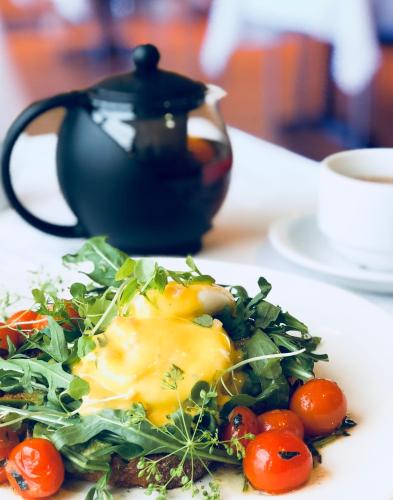 a plate of food with an egg on top of salad at Edit Picton in Picton