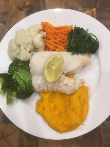 a plate of food with fish and vegetables on a table at House on the Hill Bed and Breakfast in Huonville