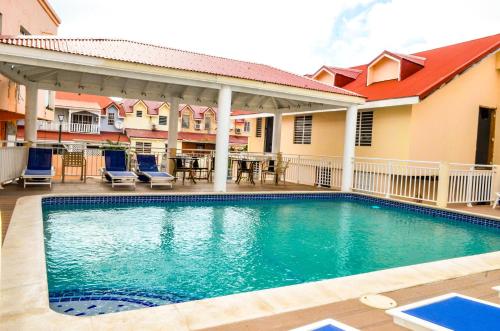 a swimming pool in front of a house at Fantastic Hotel in Marigot