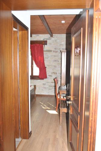 a room with a table and a red curtain at Hotel Kastro in Gjirokastër