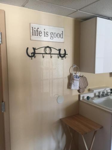 a bathroom with a sign on the wall at Economy Guest Village in Rock Springs