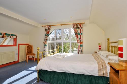 Säng eller sängar i ett rum på Boffin Lodge Guest House