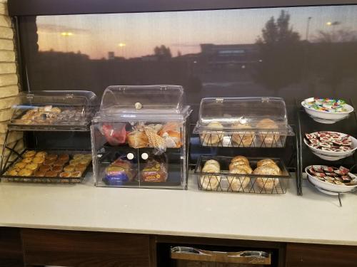 a counter with trays of different types of pastries at Baymont by Wyndham Medicine Hat in Medicine Hat