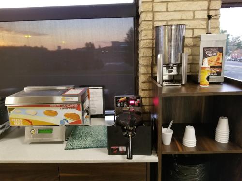 a desk with a coffee maker and a printer at Baymont by Wyndham Medicine Hat in Medicine Hat