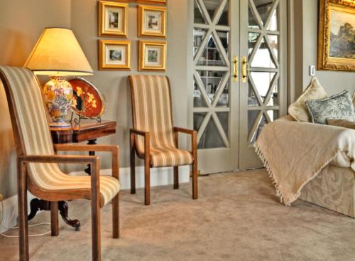 a living room with a desk and chairs and a lamp at Dyers House in Christchurch