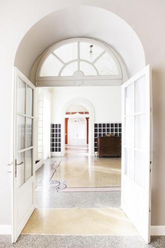an open door to a room with a building at Villa Martelli in Belgirate