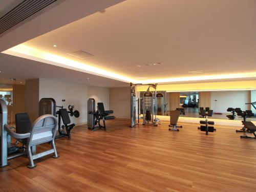 a gym with exercise equipment in a large room at Swiss Grand Xiamen-Harbour View in Xiamen