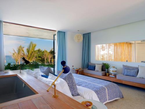 a bedroom with a bed and a pool in it at Villa Seascape by Elite Havens in Nusa Lembongan