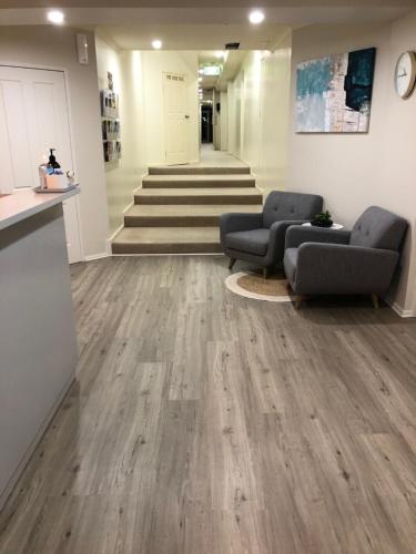 a lobby with two couches and wooden floors at Lifestyle Apartments at Ferntree in Fern Tree Gully