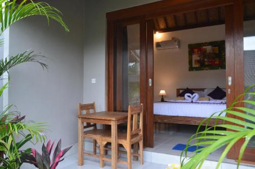 Postel nebo postele na pokoji v ubytování Buda Cottage Ubud