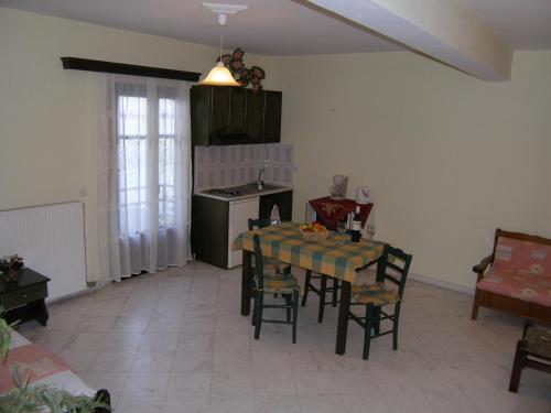 a kitchen with a table and chairs in a room at Elektra Apartments & Studios in Petra