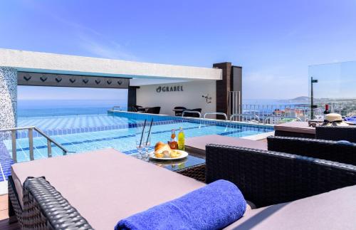 a view of a swimming pool from the balcony of a house at Grabel Hotel Jeju in Jeju