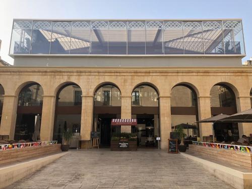 a large building with a large window on top of it at Valletta Harbour View Apartment in Valletta