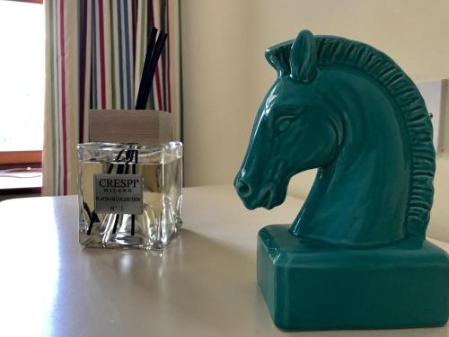 a green horse head statue on a table next to a glass at Seawell in Towcester