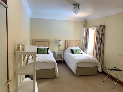 a bedroom with two beds and a window at Seawell in Towcester