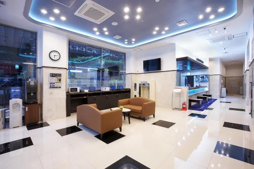 a lobby with chairs and a clock in a building at Toyoko Inn Seoul Gangnam in Seoul