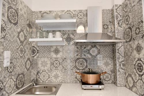 a kitchen with a sink and a pot on a stove at Ilion Luxury Apartments in Asprovalta