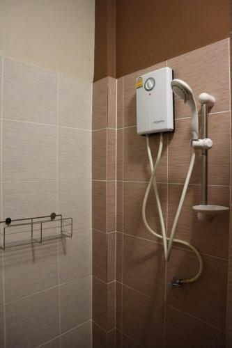 a shower in a bathroom with a shower at Ratchanee Place in Chaiyaphum