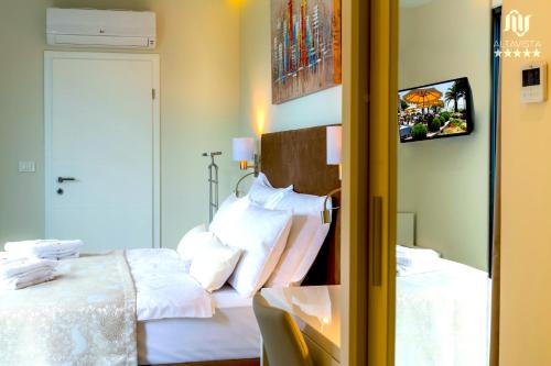 a hotel room with a bed and a mirror at Villa AltaVista - Seaview & Relax with Heated Pool & MiniGolf in Opatija