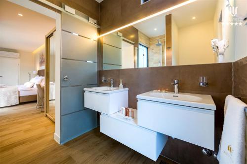 a bathroom with a sink and a mirror at Villa AltaVista - Seaview & Relax with Heated Pool & MiniGolf in Opatija