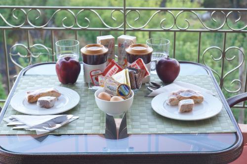 a table with plates of food and apples on it at Nontas Homes in Kalamitsi
