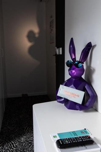 a purple bunny sitting on a table next to a keyboard at ibis Styles Lausanne Center MadHouse in Lausanne