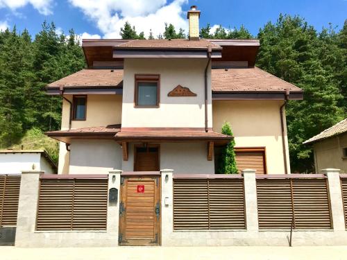 a house with a fence in front of it at Vila Rila Samokov in Samokov