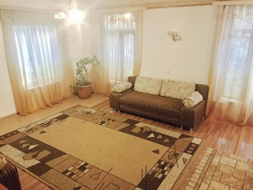 a living room with a couch and a rug at Гостиница Альянс in Karagandy